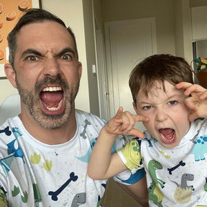 Man and boy wearing Remy dinosaur t-shirts